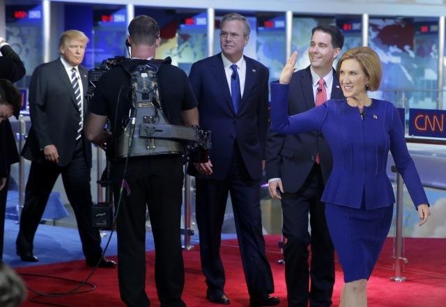 Republican presidential candidate Carly Fiorina, leads fellow candidates Scott Walker, Jeb Bush and Donald Trump as they take the stage prior to the CNN Republican presidential debate on Wednesday, Sept. 16, 2015. (AP Photo/Chris Carlson)