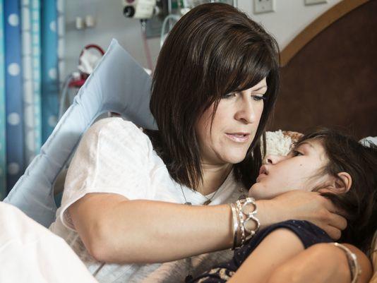 Heather Shuker comforts her daughter Hannah, 12, after a series of seizures. Photo: Lex Talamo, News21