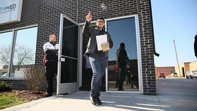 Chris Favela, who has multiple sclerosis, is the first recipient of medical marijuana at a dispensary in Addison, Illinois on November 9. Image: Stacey Wescott, Chicago Tribune