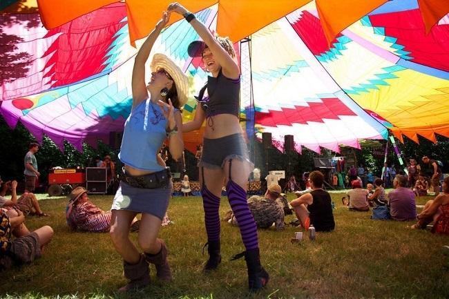 Love Erchul, left, and Polly Bates, right, dance together at The Oregon Country Fair in 2013. Brittany Greeson/ The Oregonian