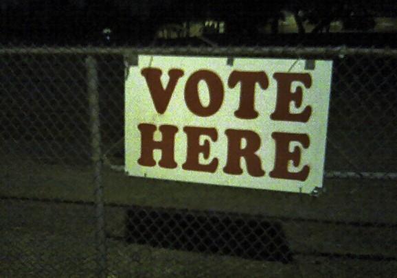 Voting sign at night. Image: Ben Combee, Austin TX via Wikimedia Commons