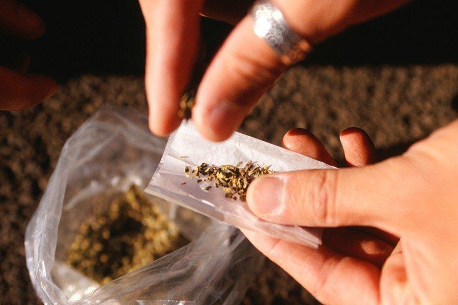 Image of cannabis being rolled into a joint